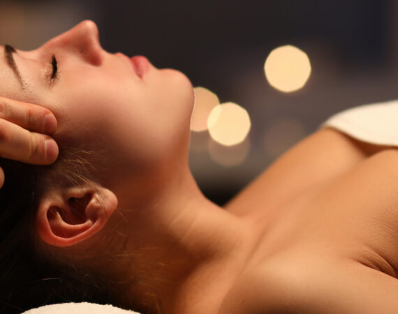 Woman lay on couch on her back with closed eyes and enjoy.